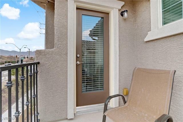 property entrance featuring a balcony and a mountain view