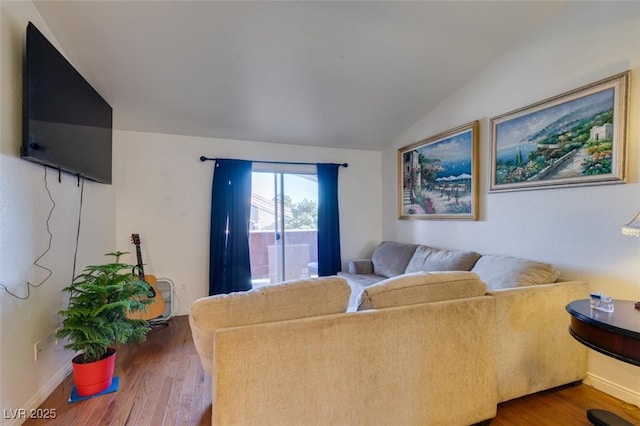 living room featuring wood-type flooring and vaulted ceiling