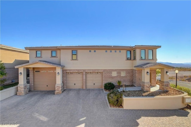 view of front of property featuring a mountain view and a garage