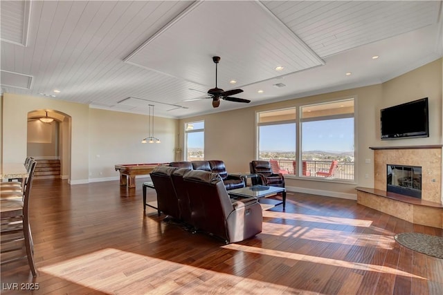 living room featuring crown molding, wood ceiling, wood-type flooring, and ceiling fan