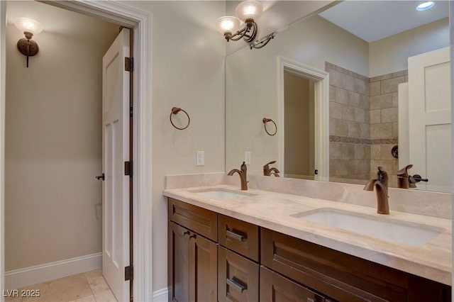 bathroom with tiled shower, tile patterned floors, and vanity