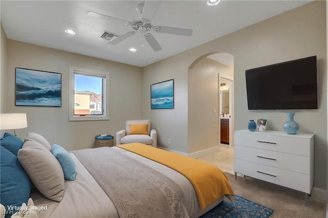 bedroom with ensuite bathroom and ceiling fan