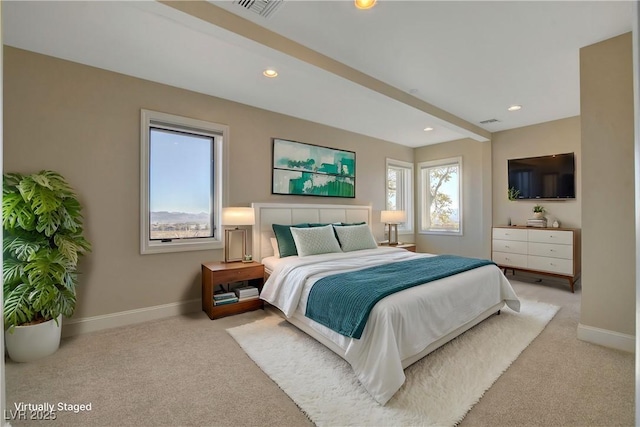 bedroom with light carpet and beam ceiling