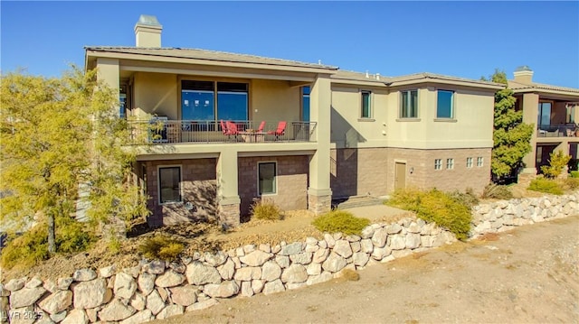 view of side of home with a balcony