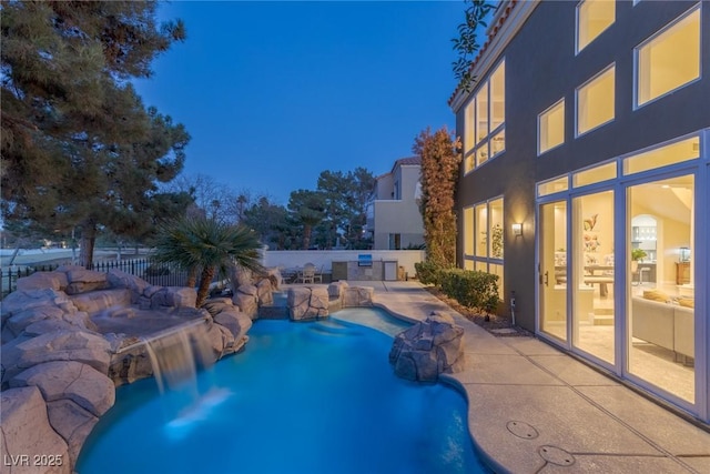 view of swimming pool with a patio area, fence, and a fenced in pool