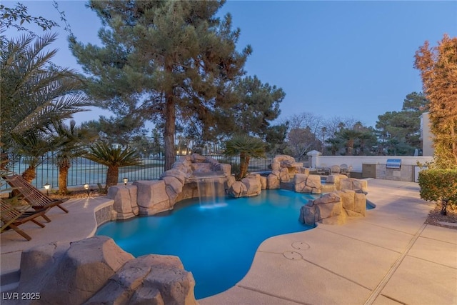 view of pool with a patio, grilling area, fence, and a fenced in pool