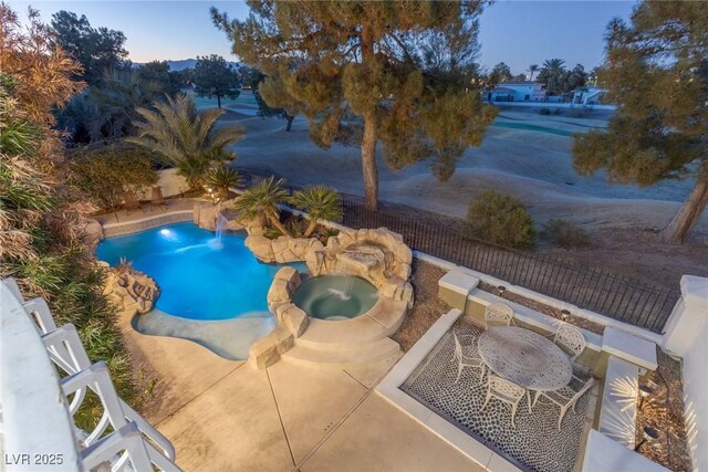 view of swimming pool with a patio area and an in ground hot tub