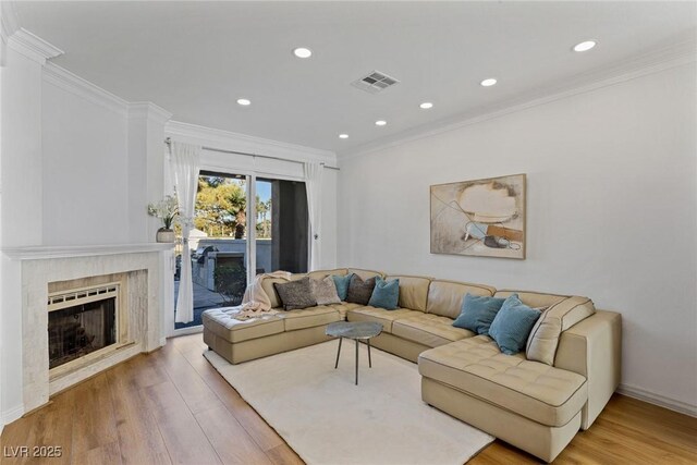 living room featuring ornamental molding and hardwood / wood-style floors