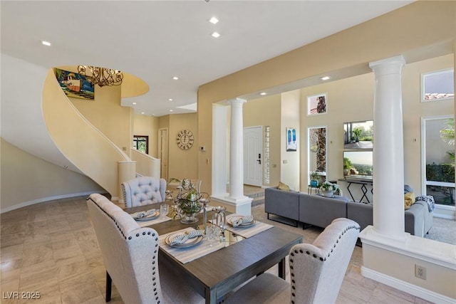 dining room featuring decorative columns, a wealth of natural light, and recessed lighting