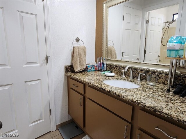 bathroom with tile patterned flooring and vanity