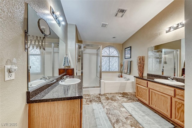 bathroom featuring vanity and independent shower and bath