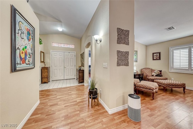 entrance foyer featuring lofted ceiling and light hardwood / wood-style flooring