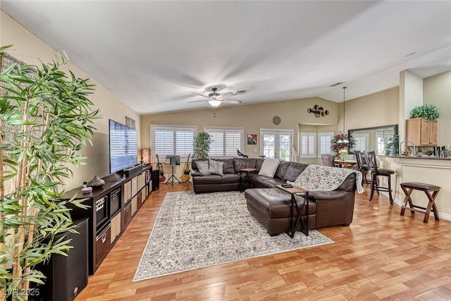 living room featuring vaulted ceiling, ceiling fan, light hardwood / wood-style floors, and french doors