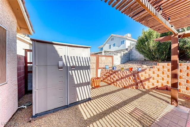 wooden deck featuring a pergola and a shed