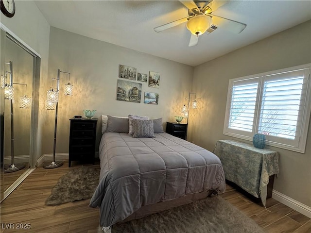 bedroom with wood-type flooring and ceiling fan