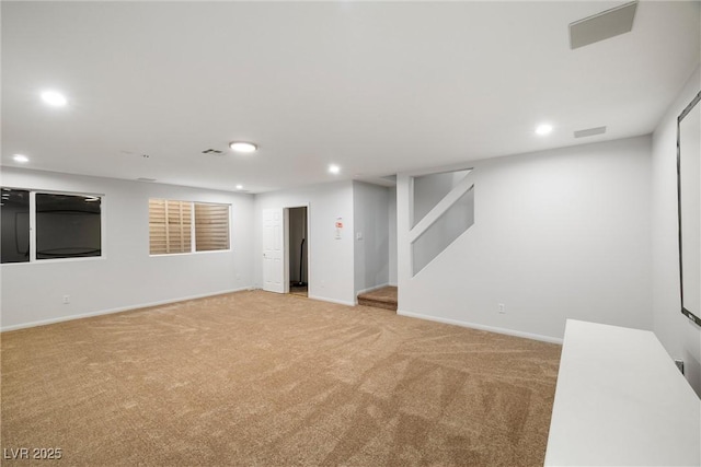 finished below grade area featuring stairs, recessed lighting, baseboards, and light colored carpet