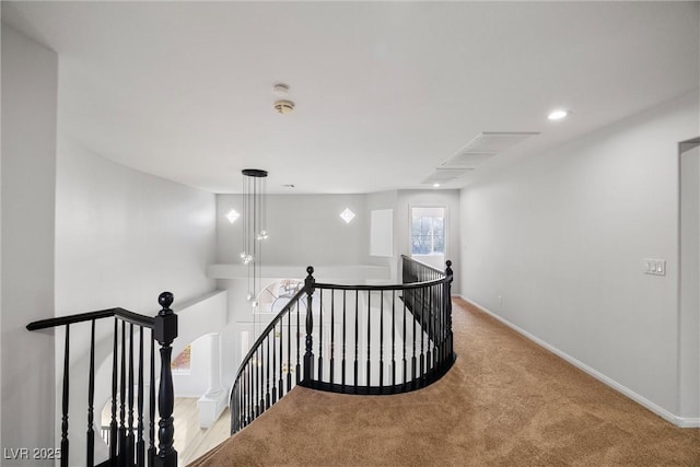 corridor with recessed lighting, baseboards, light colored carpet, and an upstairs landing