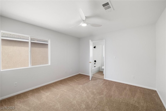 unfurnished room with ceiling fan, carpet flooring, visible vents, and baseboards