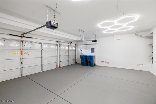 garage with a garage door opener and electric panel