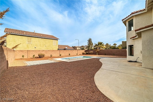 view of yard featuring a fenced in pool, a patio area, and a fenced backyard