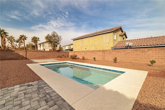 view of swimming pool featuring a fenced in pool, a fenced backyard, and a patio