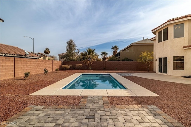 view of pool with a fenced backyard, a fenced in pool, and a patio