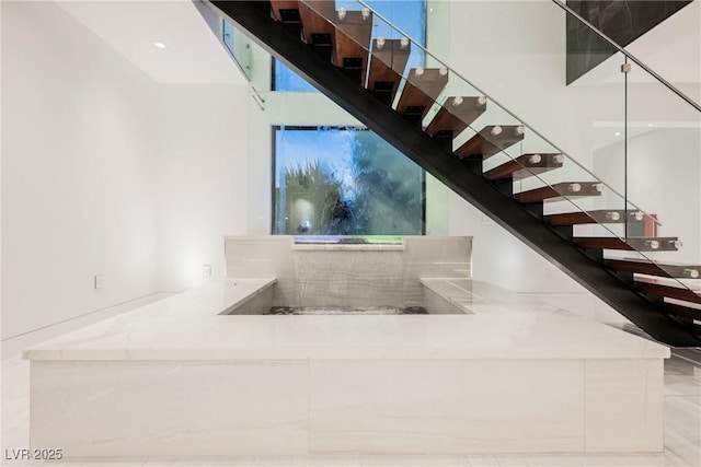 staircase featuring a high ceiling