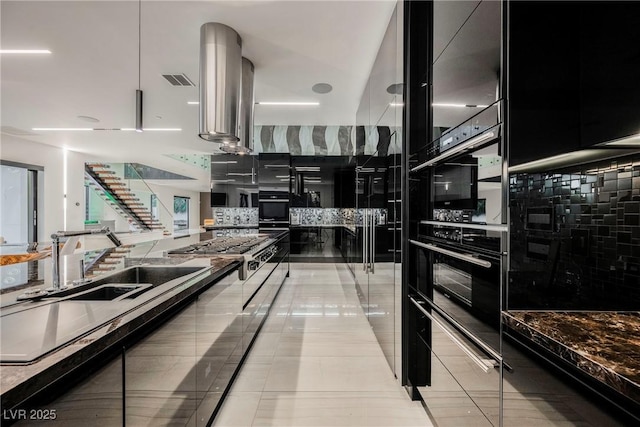 kitchen with tasteful backsplash, island exhaust hood, light tile patterned flooring, and stainless steel gas cooktop