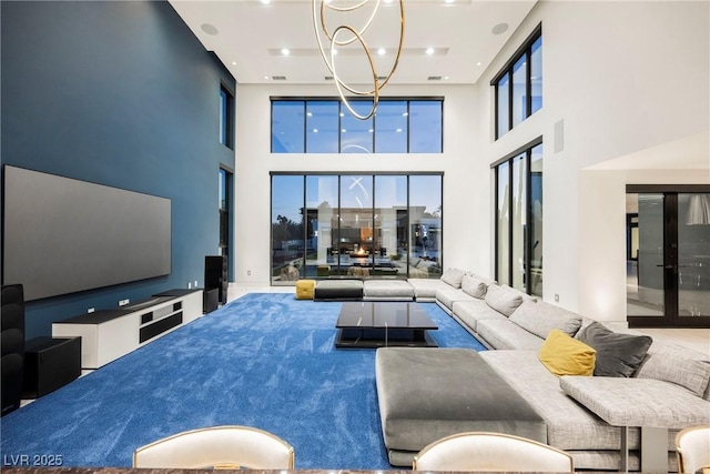 living room with a notable chandelier and a high ceiling