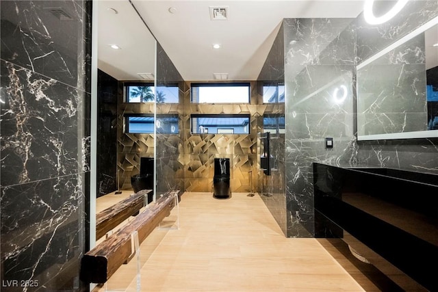 bathroom featuring tile walls