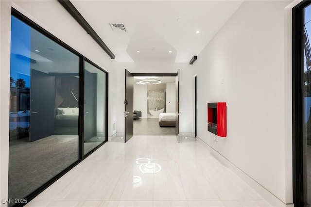 hall with light tile patterned floors