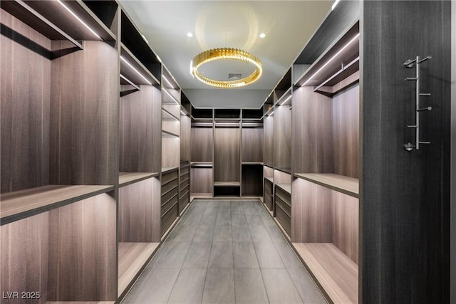 spacious closet with light tile patterned floors