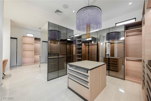 spacious closet with an inviting chandelier and elevator