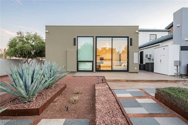 rear view of house with a patio and central air condition unit