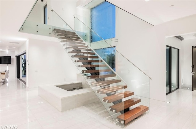 stairway with a towering ceiling