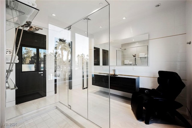 bathroom featuring tile patterned flooring, vanity, and walk in shower