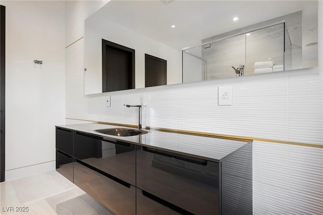 kitchen featuring light tile patterned floors, sink, and backsplash