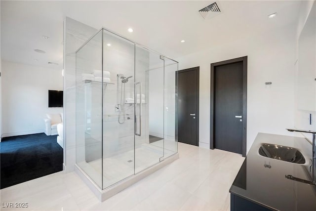 bathroom featuring tile patterned flooring, sink, and an enclosed shower