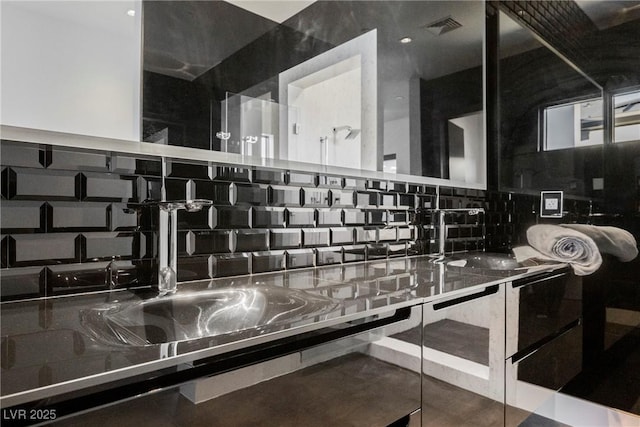 interior details featuring sink and decorative backsplash