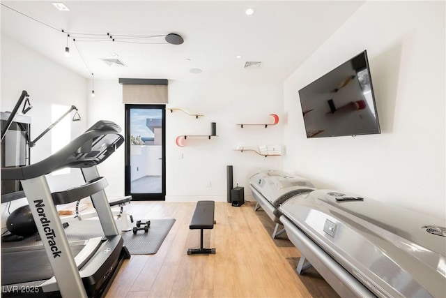 exercise area featuring light hardwood / wood-style flooring