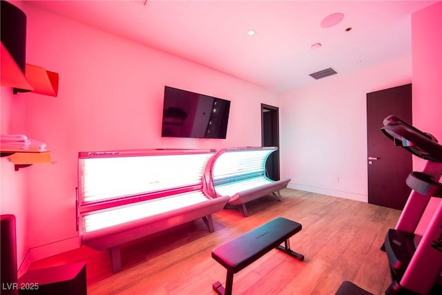 workout room featuring light hardwood / wood-style flooring