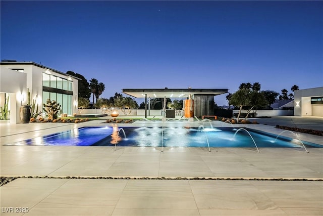 pool at dusk with pool water feature