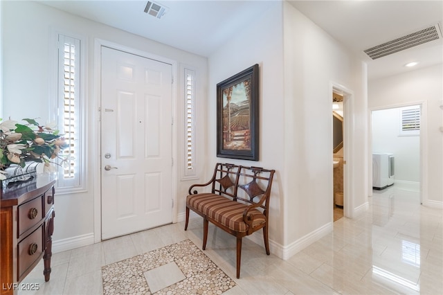 tiled foyer featuring washer / dryer