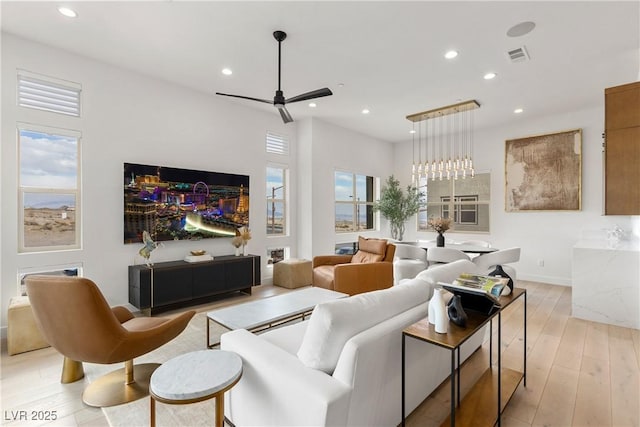 living room featuring ceiling fan and light wood-type flooring