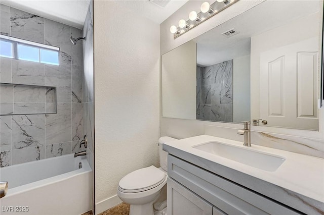 full bathroom featuring vanity, tiled shower / bath combo, and toilet