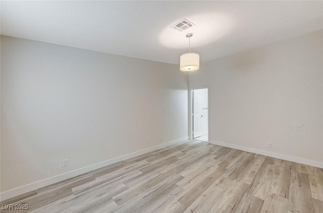 spare room featuring light hardwood / wood-style floors