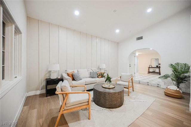 living room with lofted ceiling and light wood-type flooring