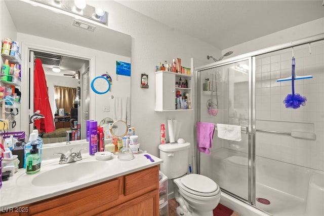 bathroom with vanity, an enclosed shower, and toilet