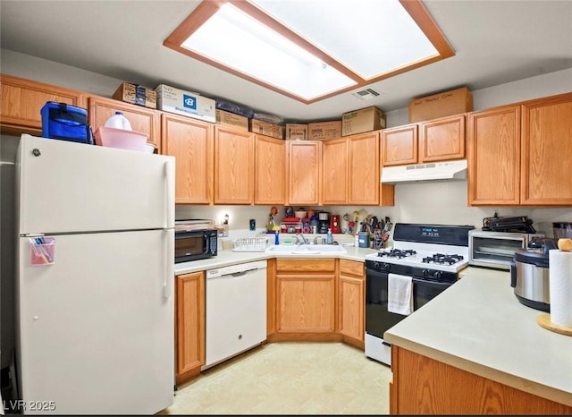 kitchen featuring white appliances and sink