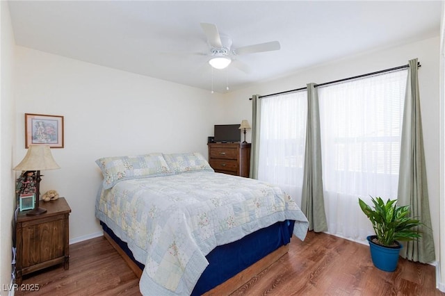 bedroom with ceiling fan and hardwood / wood-style floors